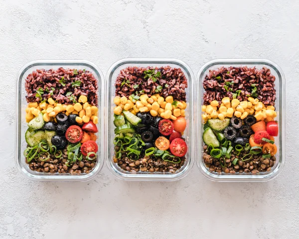 Freshly prepared meals with rice, lentils and colourful vegetables.