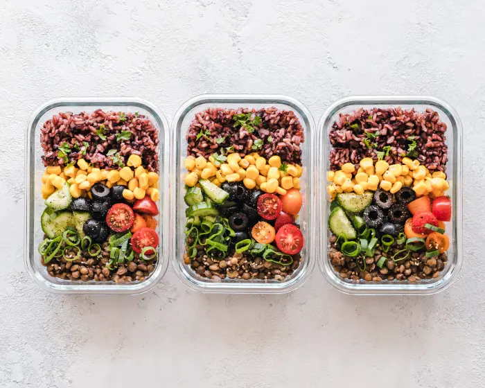 Prepared meals arranged carefully in individual containers.